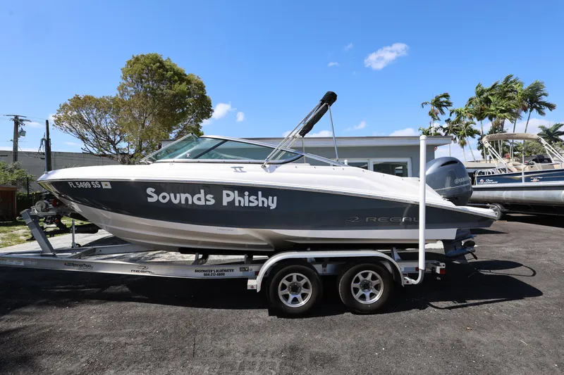 Slide: The Image of 2022 Regal 21 OBX boat on trailer, labeled "Sounds Phishy," under clear blue sky. - 19