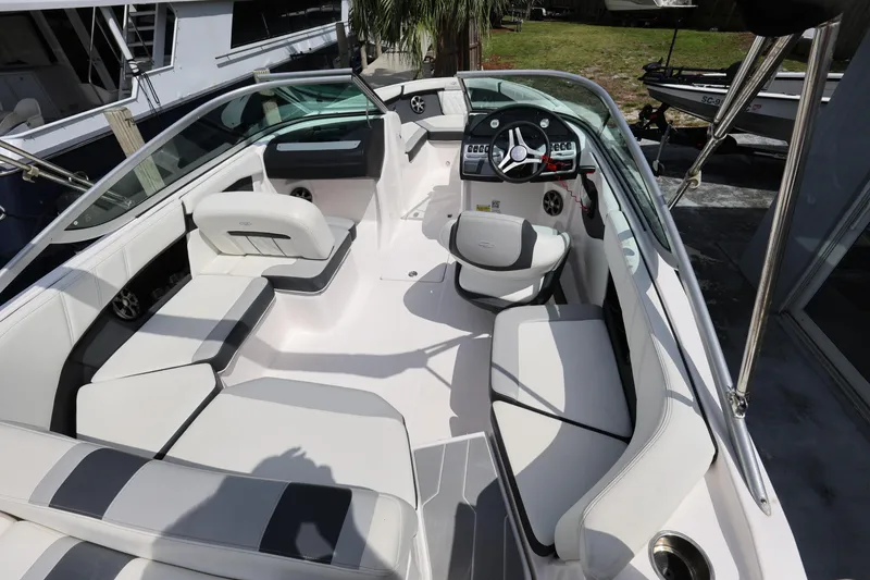Slide: The Image of 2022 Regal 21 OBX boat interior with modern seating and steering console. - 22