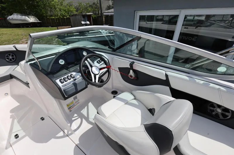 Slide: The Image of 2022 Regal 21 OBX boat interior with sleek dashboard and comfortable seating. - 23