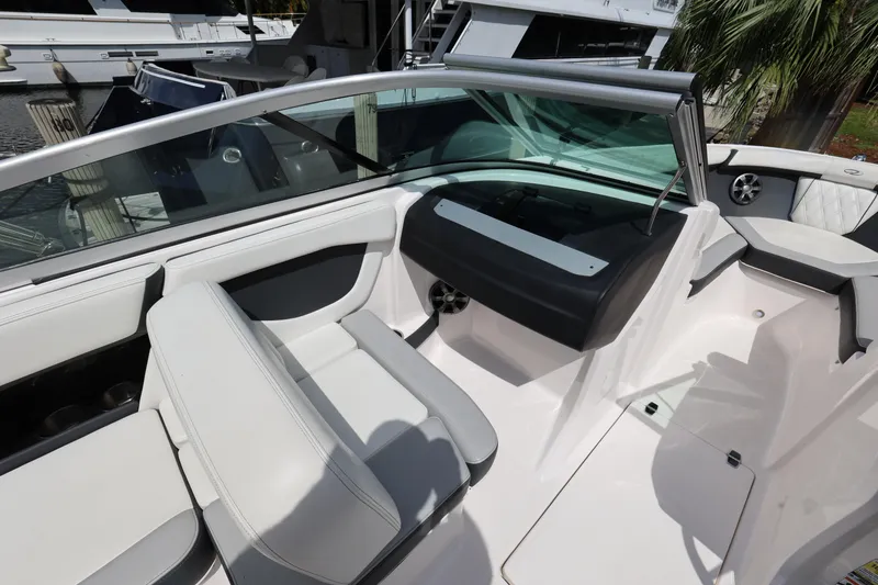 Slide: The Image of 2022 Regal 21 OBX boat interior with white seating and sleek design. - 24