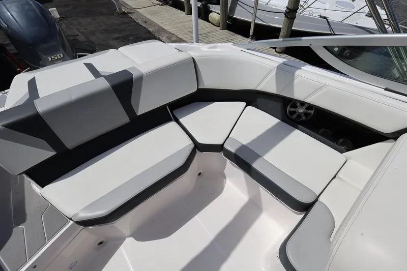 Slide: The Image of 2022 Regal 21 OBX boat interior with cushioned seating and sleek design. - 25