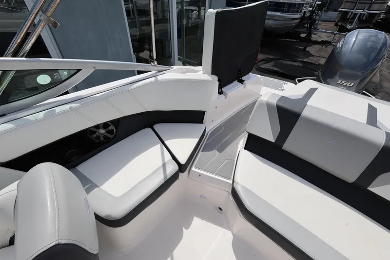 Slide: The Image of 2022 Regal 21 OBX boat interior with white seating and modern design. - 26