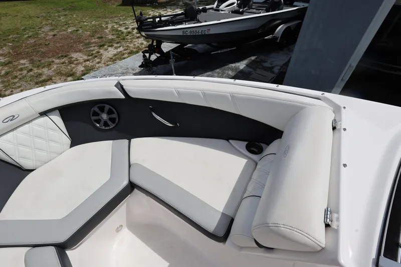 Slide: The Image of 2022 Regal 21 OBX boat interior with white cushioned seating and speaker. - 28