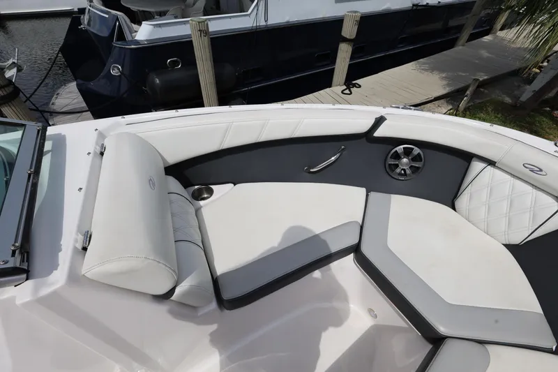 Slide: The Image of 2022 Regal 21 OBX boat interior with white seating and cup holder. - 29