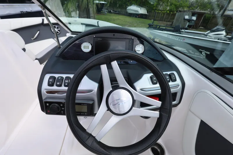 Slide: The Image of 2022 Regal 21 OBX boat dashboard with steering wheel and control panel. - 31