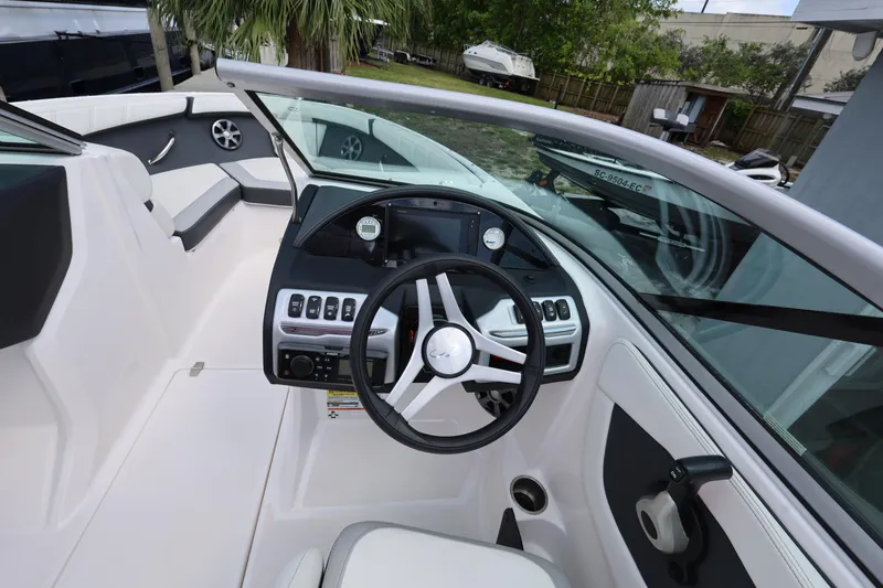 Slide: The Image of 2022 Regal 21 OBX boat interior with steering wheel and dashboard controls. - 33