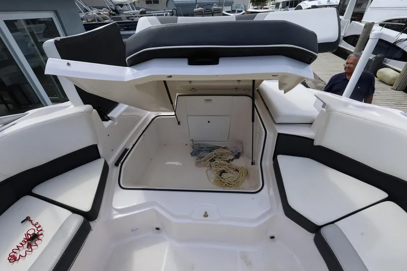 Slide: The Image of 2022 Regal 21 OBX boat with open storage compartment and seating area. - 35