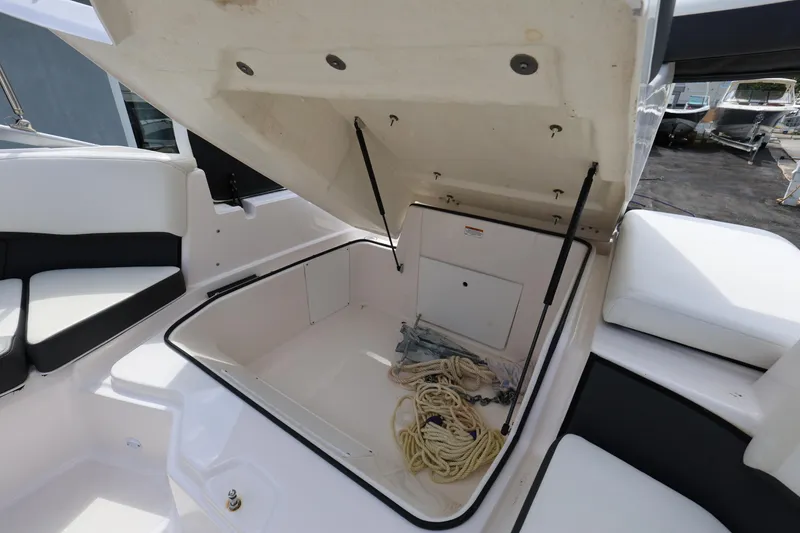 Slide: The Image of Open storage compartment on 2022 Regal 21 OBX boat with ropes inside. - 36
