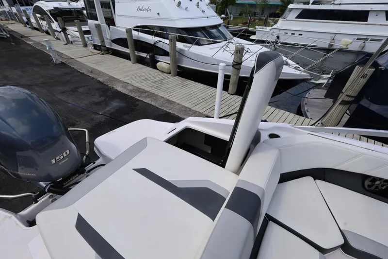 Slide: The Image of 2022 Regal 21 OBX boat docked, featuring sleek seating and powerful outboard motor. - 38
