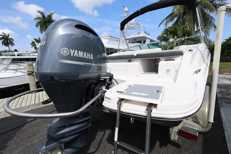 Slide: The Image of 2022 Regal 21 OBX boat with Yamaha outboard motor, docked near palm trees. - 40