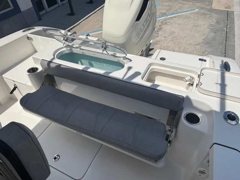 Slide: The Image of 2021 Sea Pro 239 Center Console boat interior with seating and storage compartments. - 5