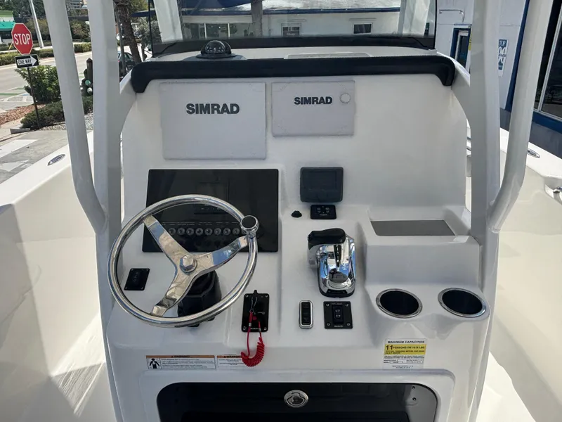 Slide: The Image of 2021 Sea Pro 239 Center Console helm with Simrad electronics and stainless steel steering wheel. - 8