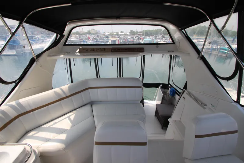 Slide: The Image of Interior of 2002 Carver 366 Motor Yacht with white seating and marina view. - 12