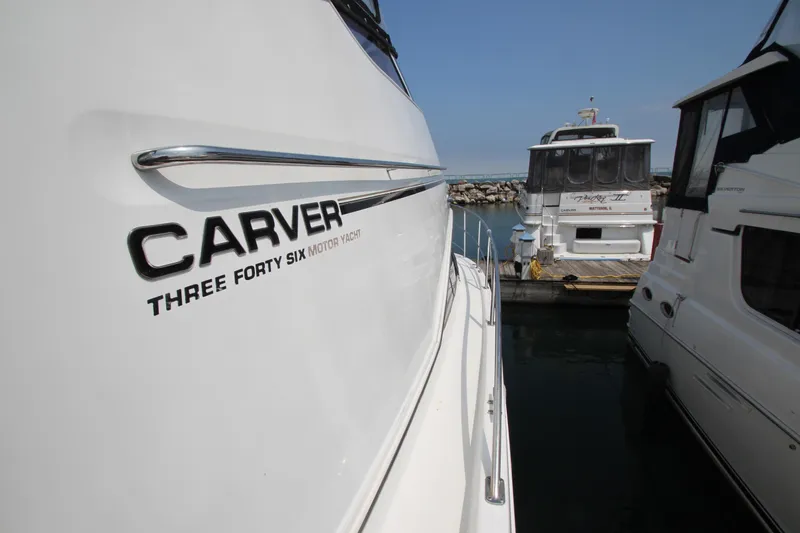 Slide: The Image of 2002 Carver 366 Motor Yacht docked at marina, side view with logo visible. - 19
