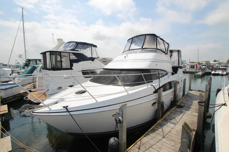 Slide: The Image of 2002 Carver 366 Motor Yacht docked at a marina under a cloudy sky. - 2