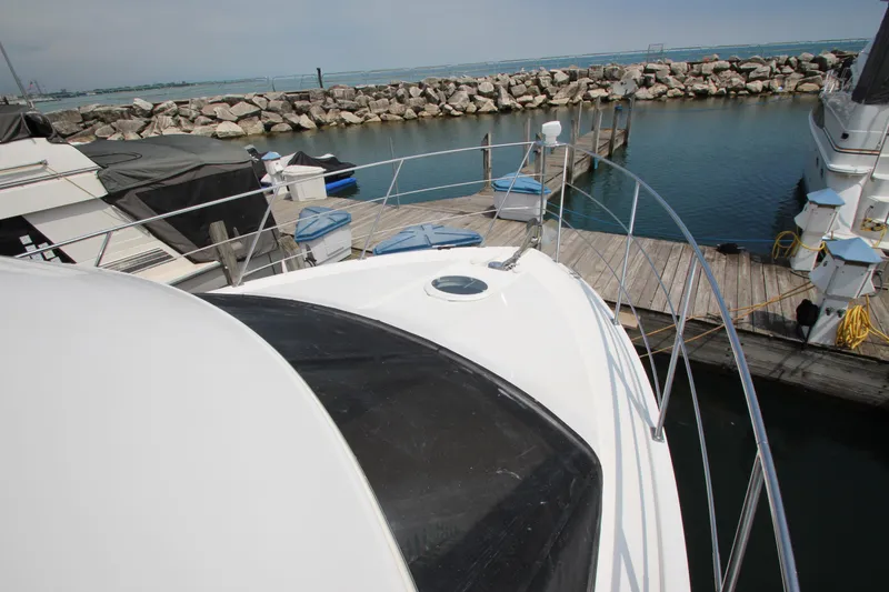 Slide: The Image of 2002 Carver 366 Motor Yacht docked at marina with rocky shoreline. - 20