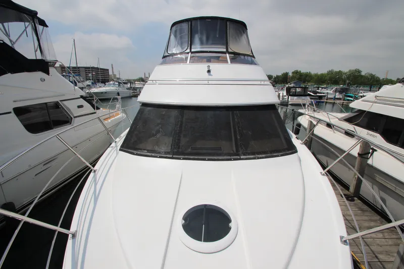 Slide: The Image of 2002 Carver 366 Motor Yacht docked at a marina, showcasing sleek design and spacious deck. - 22