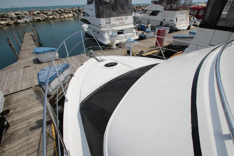 Slide: The Image of 2002 Carver 366 Motor Yacht docked at marina with other boats. - 23