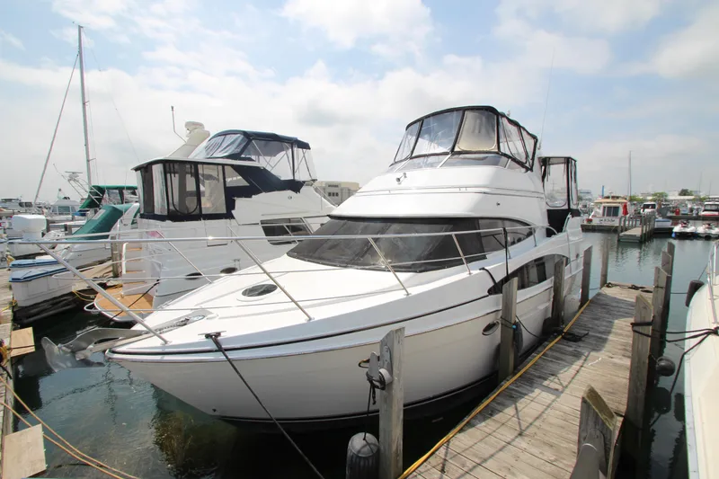 Slide: The Image of 2002 Carver 366 Motor Yacht docked at a marina under a cloudy sky. - 3