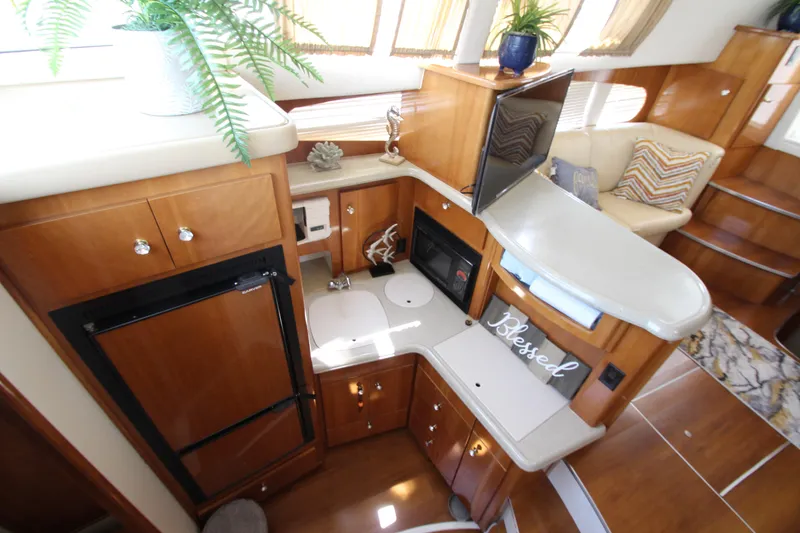 Slide: The Image of Interior of 2002 Carver 366 Motor Yacht with modern kitchen and cozy seating area. - 30