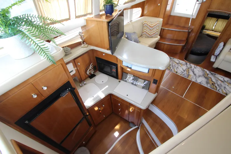 Slide: The Image of Interior of 2002 Carver 366 Motor Yacht with modern kitchen and cozy seating area. - 33