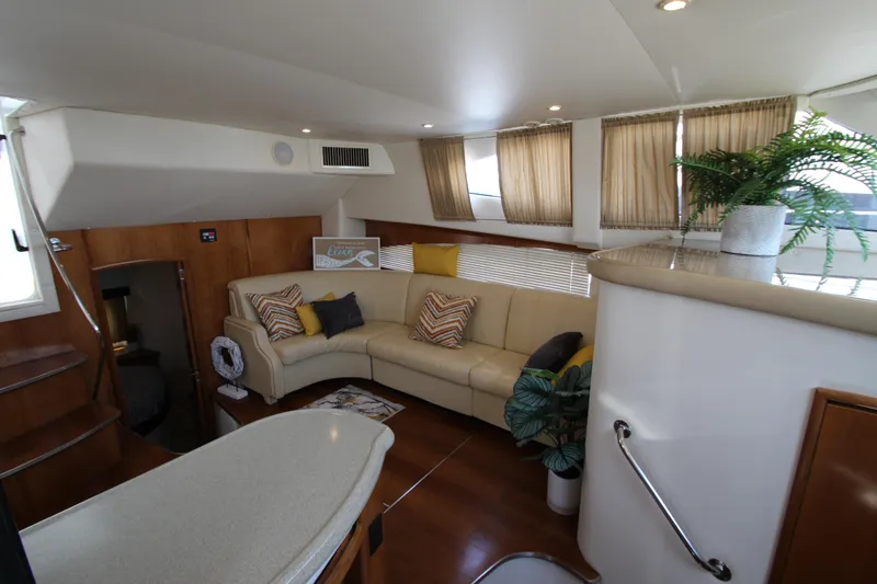 Slide: The Image of Luxurious interior of 2002 Carver 366 Motor Yacht with cozy seating and elegant decor. - 36