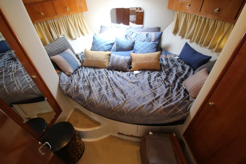 Slide: The Image of Luxurious bedroom interior of 2002 Carver 366 Motor Yacht with plush bedding and wooden cabinetry. - 37