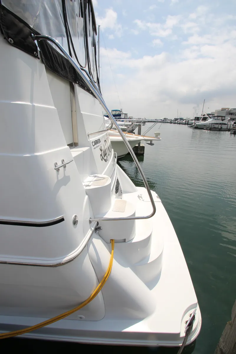 Slide: The Image of 2002 Carver 366 Motor Yacht docked at marina, rear view. - 4