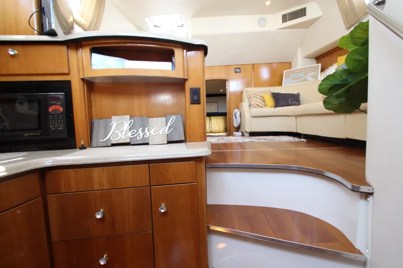 Slide: The Image of Interior of 2002 Carver 366 Motor Yacht with wooden cabinetry and cozy seating area. - 41