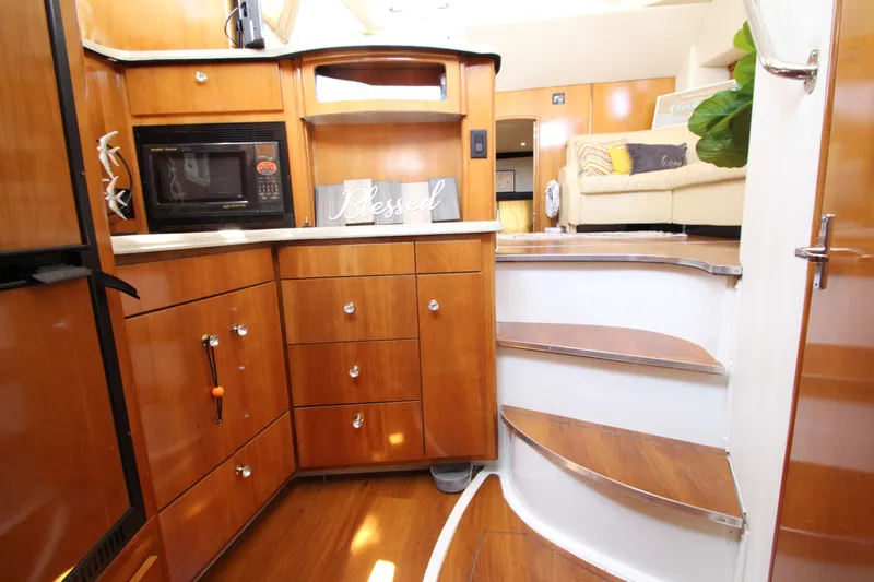 Slide: The Image of Interior of 2002 Carver 366 Motor Yacht with wooden cabinetry and modern amenities. - 42