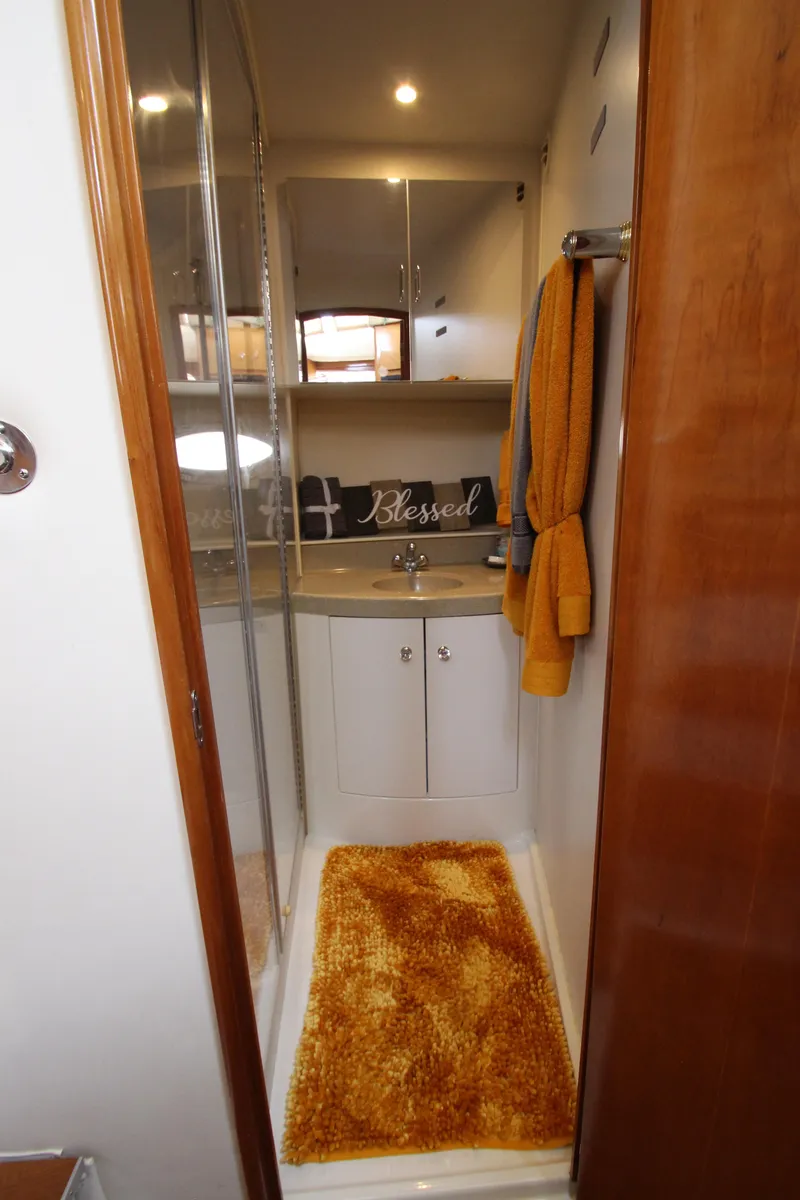 Slide: The Image of Bathroom interior of 2002 Carver 366 Motor Yacht with orange rug and towels. - 44