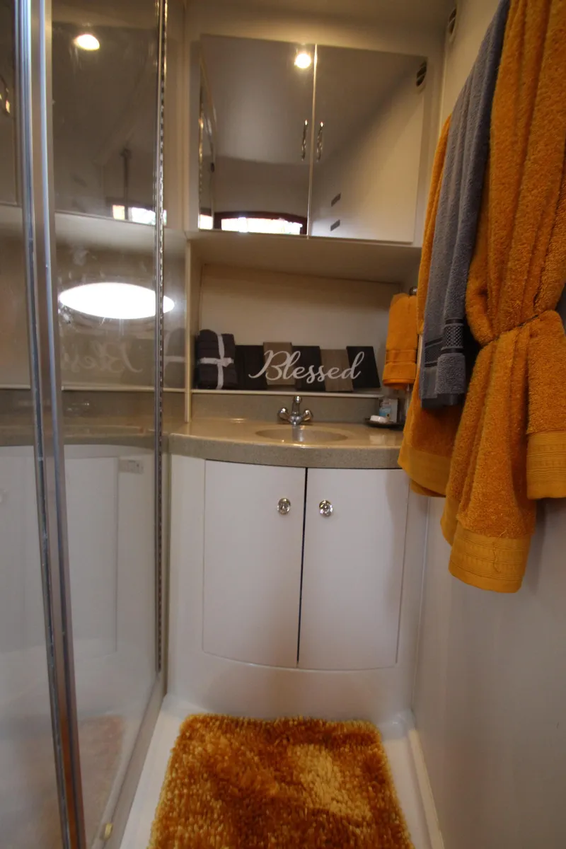 Slide: The Image of Bathroom interior of 2002 Carver 366 Motor Yacht with orange towels and "Blessed" sign. - 45