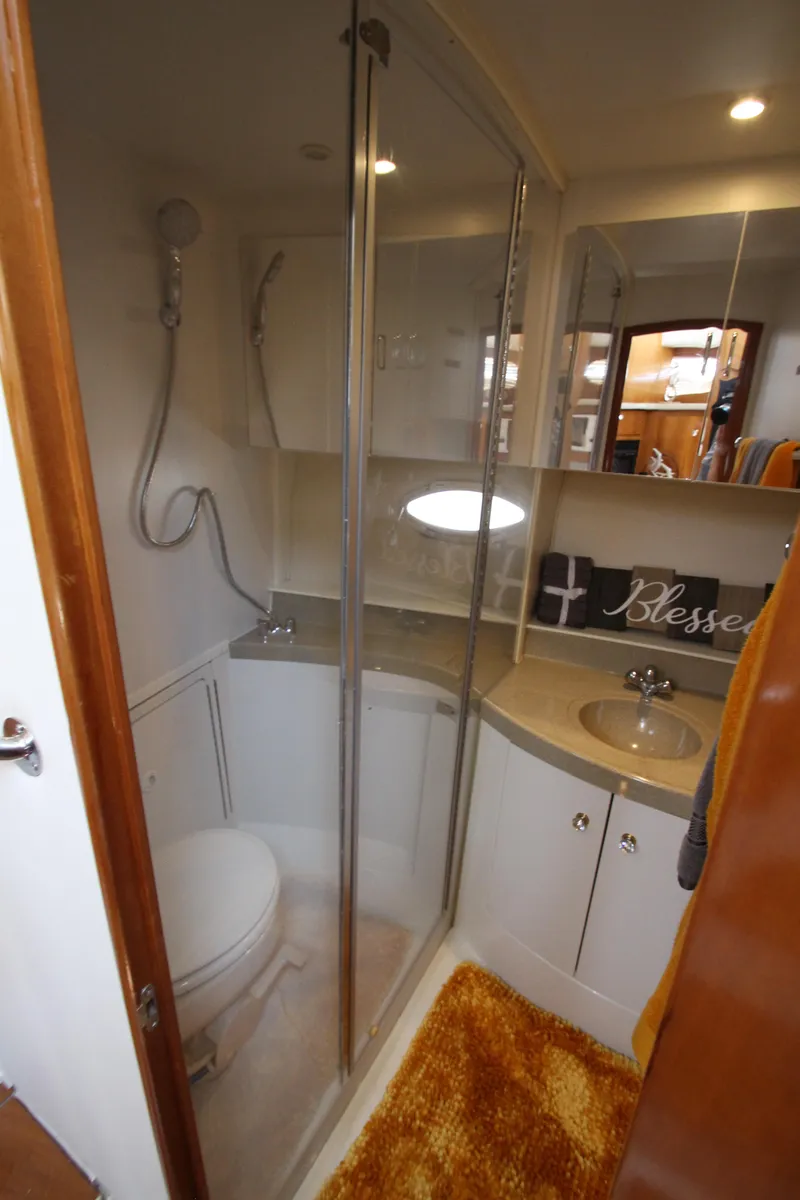 Slide: The Image of 2002 Carver 366 Motor Yacht bathroom with shower, sink, and toilet. - 47