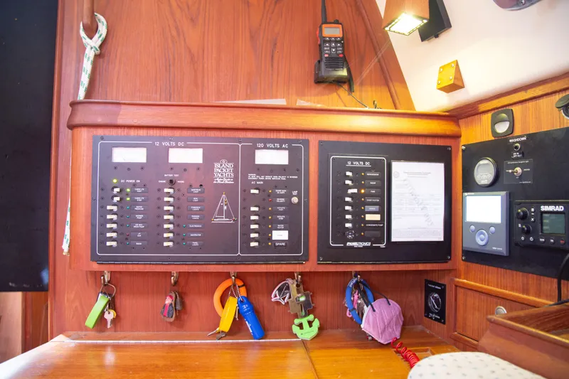 Slide: The Image of Electrical panel of a 1999 Island Packet 380 sailboat with various controls and keys. - 14