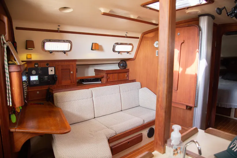 Slide: The Image of Interior of 1999 Island Packet 380 sailboat with cozy seating and wooden accents. - 20