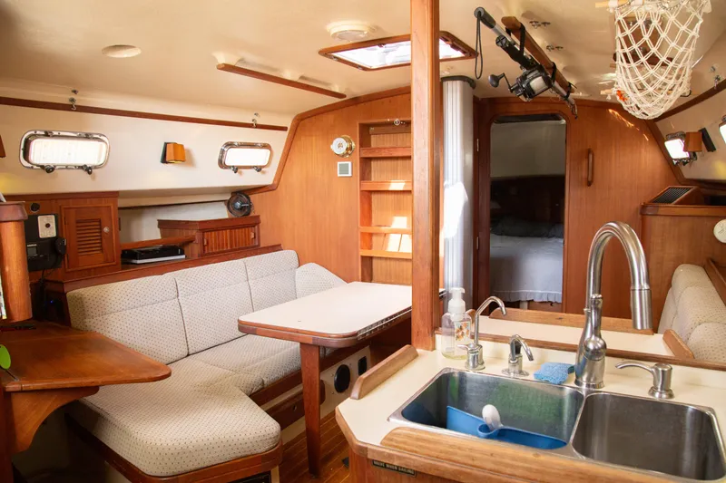 Slide: The Image of Interior of 1999 Island Packet 380 sailboat with cozy seating and kitchen area. - 22