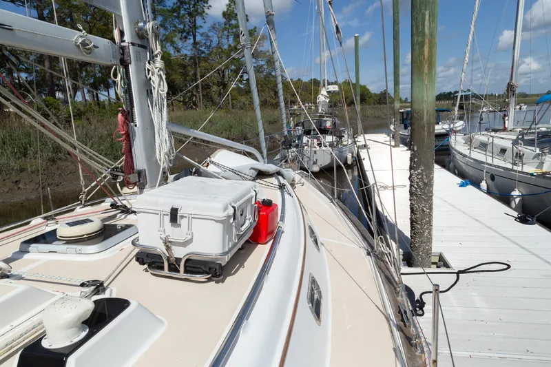 Slide: The Image of Sailboat docked at marina, Island Packet 380, 1999 model, with clear skies and calm waters. - 24