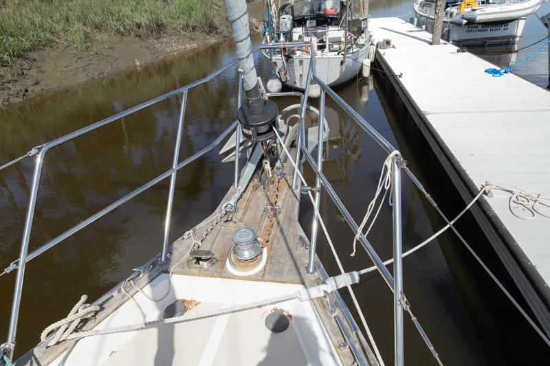Slide: The Image of Bow view of 1999 Island Packet 380 sailboat docked at marina. - 25