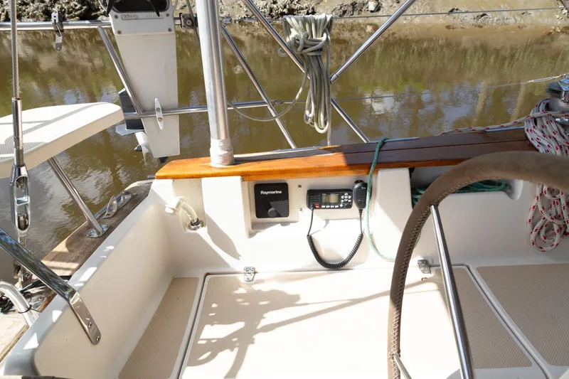 Slide: The Image of Cockpit of 1999 Island Packet 380 sailboat with navigation equipment and ropes. - 33