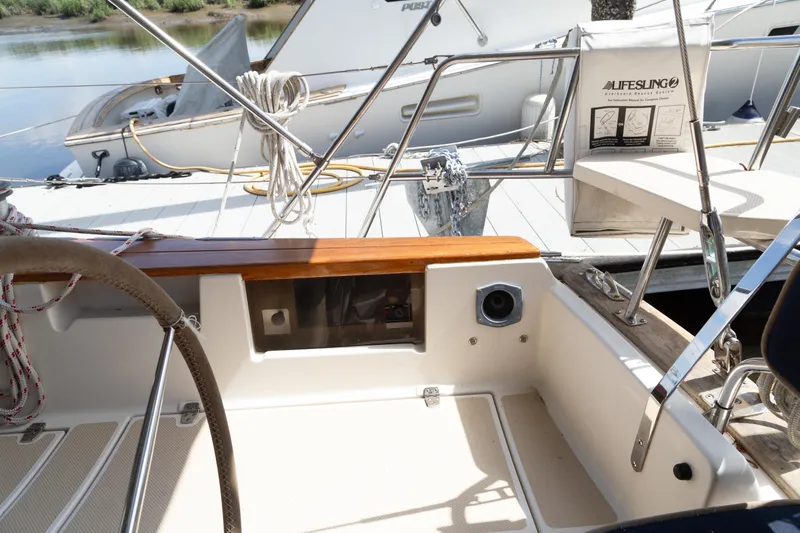 Slide: The Image of Cockpit of 1999 Island Packet 380 sailboat with steering wheel and lifebuoy. - 35