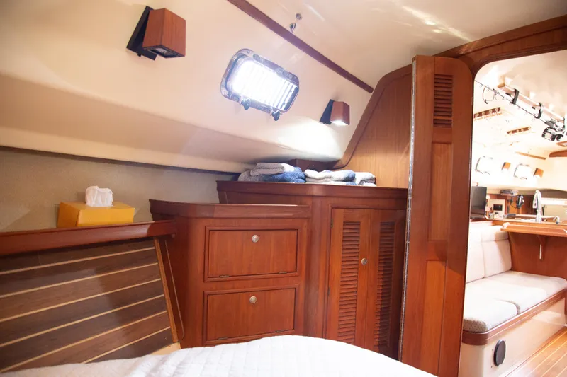 Slide: The Image of Cozy interior of 1999 Island Packet 380 sailboat with wooden cabinetry and soft lighting. - 6