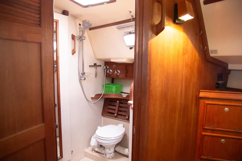 Slide: The Image of 1999 Island Packet 380 yacht bathroom with wooden cabinetry and shower. - 7