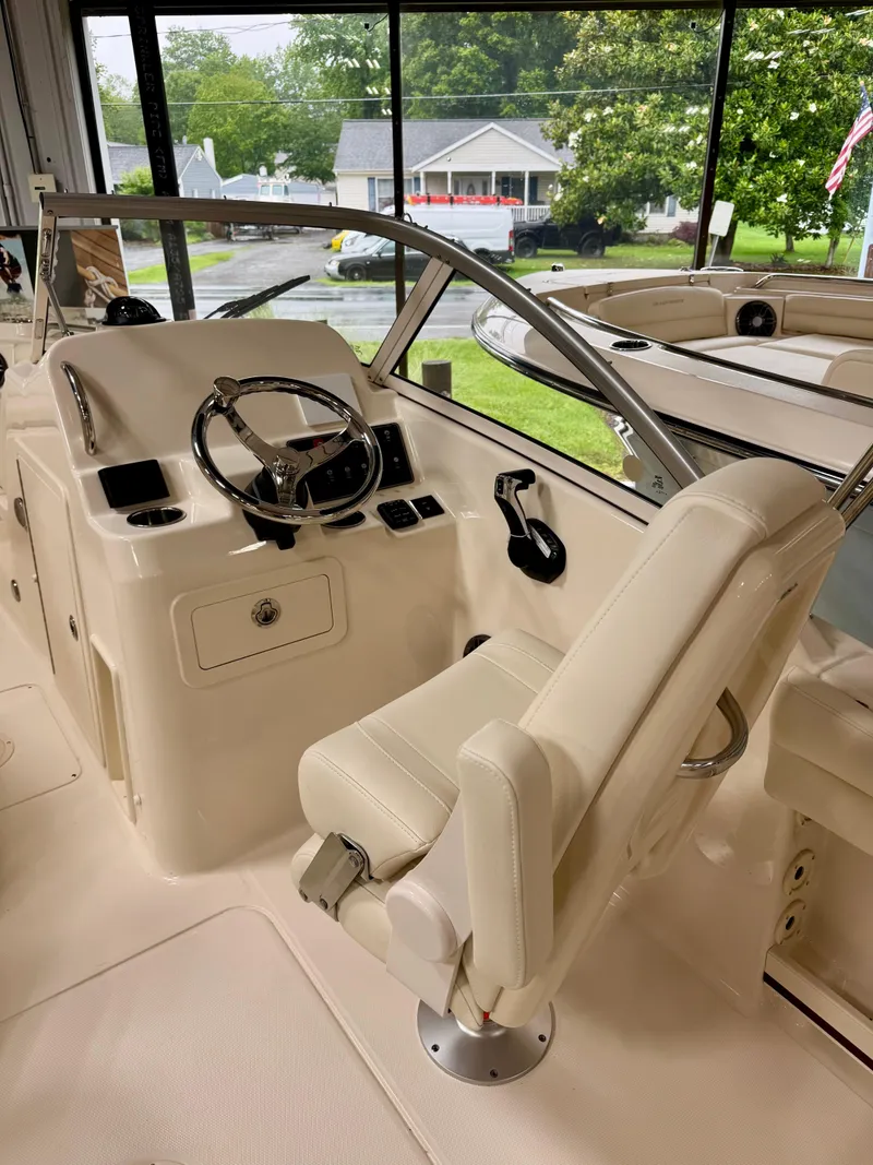 Slide: The Image of 2025 Grady-White Freedom 215 boat interior with steering wheel and seating. - 6