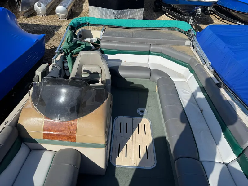 Slide: The Image of 1999 Sun Tracker Party Deck 21 interior with spacious seating and helm. - 11