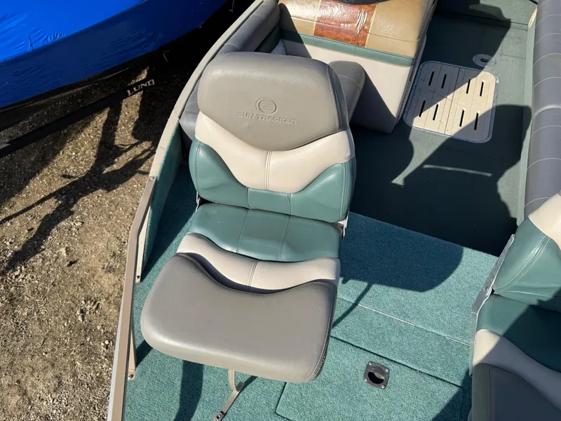 Slide: The Image of Control panel of a 1999 Sun Tracker Party Deck 21 with fish finder and throttle. - 14