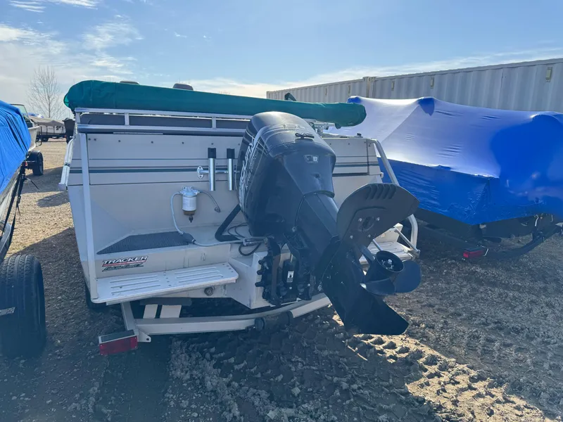 Slide: The Image of 1999 Sun Tracker Party Deck 21 boat on trailer in warehouse setting. - 3