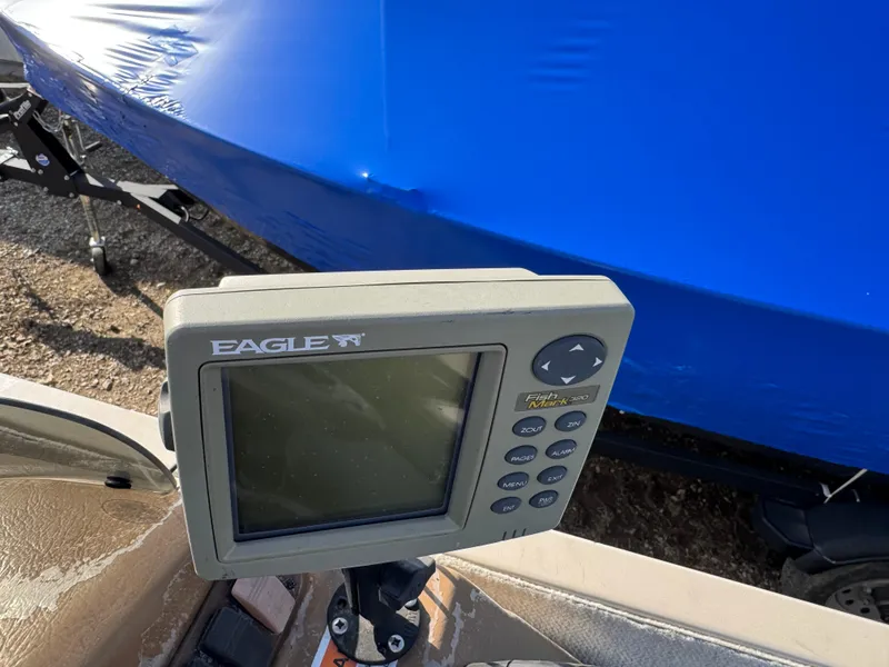 Slide: The Image of 1999 Sun Tracker Party Deck 21 boat interior with gray seating and dashboard. - 9