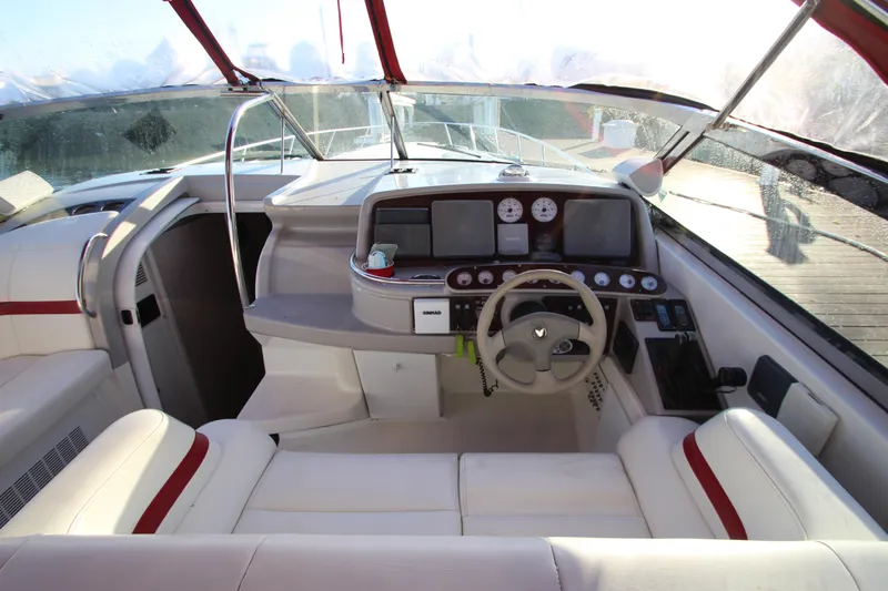Slide: The Image of 2001 Formula 400 Super Sport boat cockpit with white seating and modern dashboard. - 11