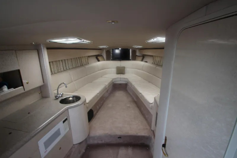 Slide: The Image of Interior of 2001 Formula 400 Super Sport boat with seating and kitchenette. - 16