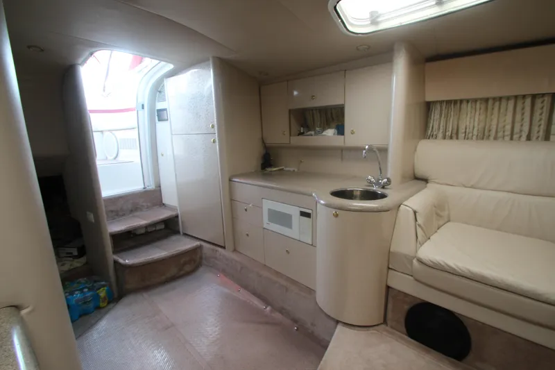 Slide: The Image of 2001 Formula 400 Super Sport yacht interior with kitchenette and seating area. - 20